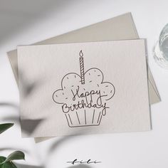 a happy birthday card with a cupcake on it and a candle in the middle