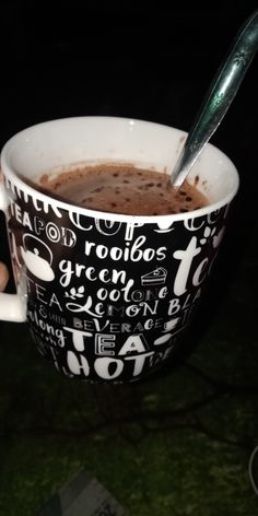 a cup of hot chocolate with a spoon in it