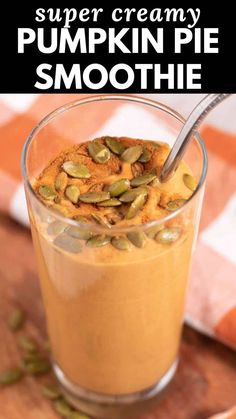 pumpkin pie smoothie in a glass on a wooden table with text overlay that reads, super creamy pumpkin pie smoothie