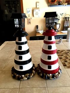 two decorative lighthouses sitting on top of a kitchen counter