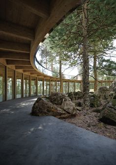 the inside of a building with large rocks and trees