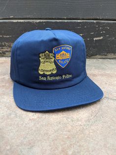 Vintage 80's 90's San Antonio Texas Police Department Snapback Hat. Has fading, yellowing, discoloring on headband, spots and other wear. NO holes. In good vintage condition... Ready To Wear One Size Fits Most. Vintage Blue Dad Hat, Vintage Blue Snapback Hat For Streetwear, Vintage Pre-washed Dad Cap, Vintage Pre-washed Dad Hat, Vintage Style Snapback Hat With Letter Print For Streetwear, Vintage Letter Print Snapback Hat For Streetwear, Vintage Dad Hat With Letter Print, Vintage Snapback Hat With Letter Print, Vintage Pre-washed Snapback Baseball Cap