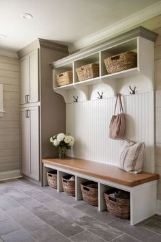 A mudroom entryway with a tile floor, built-in storage, and a sleek, modern bench. L Shaped Entryway Ideas, Front Entry Way Cubbies, Mini Mudroom, Small Entryway Drop Zone Storage Minimal, Neutral Mudroom, Entryway Storage Bench Shoe Cubby, Entryway Cubby Shelf With Hooks, Entrhway Small Cubby Storage, Foyer Storage