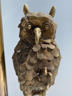 an owl statue on top of a building