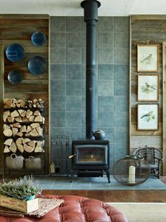 a living room filled with furniture and a wood burning stove in the middle of it