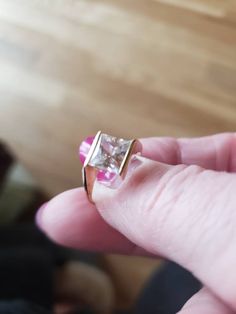 This ring is in 14kt yellow gold and has a 1.5 carat diamonique synthetic diamond. The size is 5 and is sizeable. This ring is bezel set on two sides and open on the other two, this allows the light to come in and makes the ring sparkle. The princess cut stone is set on an angle, and is so beautiful. This ring looks and feels like a million bucks Please don't purchase this on advertising sites and instead visit my store sedonasthings at Etsy thank you Gold Princess Cut Jewelry With Tension Setting, 14k Gold Princess Cut Ring With Tension Setting, Channel Set Princess Cut Rings, Gold Jewelry With Tension Setting And Princess Cut, Princess Cut Diamond Promise Ring With Bezel Setting, 14k Gold Jewelry With Princess Cut And Bezel Setting, 14k Gold Jewelry With Bezel Setting In Princess Cut, Princess Cut Diamond Ring With Bezel Setting, Princess Cut Diamond Ring With Tension Setting