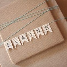 two brown envelopes tied with twine and some white paper that says efaine