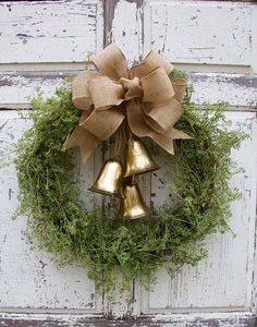 a wreath with two bells hanging from it