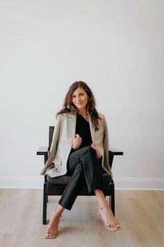 a woman sitting in a chair with her legs crossed