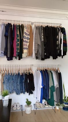 a closet with clothes hanging on the wall