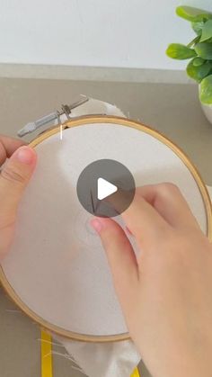 someone is working on an embroidery project with scissors