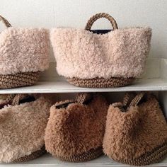 several purses sitting on top of a shelf next to each other in a room