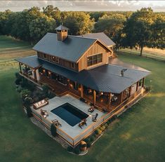 an aerial view of a large house with a pool and hot tub in the yard