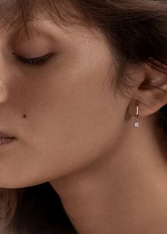 Simple and elegant—A classic pair of earrings that can go from day to night. Wear in your first piercing or mix and match in your second. Each earring features a 0.10ctw bezel set diamond.Secure snap hinge closure.Model is wearing the Marquise Angel Stud in second piercing. 14k solid gold—always. Weight: 1.4g Diameter: 12mm Carat weight: 0.20ctw Width: 2mm Diamond clarity: SI1 First Piercing, Jewelry Hoops, Nameplate Bracelet, Second Piercing, Yellow Gold Earrings, Diamond Guide, Earrings Diamond, Anniversary Jewelry, Bezel Set Diamond