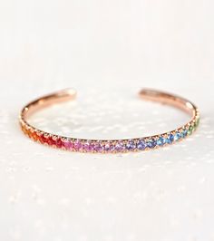 14k Rainbow Sapphire Round Cut Tennis Bracelet, Colorful Gemstones Bracelet, Open Cuff Bangle, Handmade Jewelry, Personalized Jewelry Our 14k Gold Rainbow Sapphire Round Cut Tennis Bracelet. This exquisite piece features a stunning array of round-cut sapphires in a rainbow of colors, set in luxurious 18k gold. Perfect for adding a touch of luxury to any outfit, this bracelet is a beautiful gift for a special woman in your life. 𝐆𝐞𝐦 𝐒𝐭𝐨𝐧𝐞 𝐃𝐢𝐚𝐦𝐨𝐧𝐝 𝐢𝐬 𝟏𝟎𝟎% 𝐆𝐞𝐧𝐮𝐢𝐧𝐞 𝐚𝐧𝐝 𝐑𝐞𝐚𝐥 𝐃𝐢𝐚𝐦𝐨𝐧𝐝. 𝐓𝐡𝐞𝐲 𝐚𝐫𝐞 𝐂𝐡𝐞𝐦𝐢𝐜𝐚𝐥𝐥𝐲, 𝐏𝐡𝐲𝐬𝐢𝐜𝐚𝐥𝐥𝐲 𝐚𝐧𝐝 𝐎𝐩𝐭𝐢𝐜𝐚𝐥𝐥𝐲 𝐈𝐝𝐞𝐧𝐭𝐢𝐜𝐚𝐥 𝐭𝐨 𝐍𝐚𝐭𝐮𝐫𝐚𝐥 𝐃𝐢𝐚𝐦𝐨𝐧𝐝𝐬. ✤ 𝐁𝐑𝐀𝐂𝐄𝐋𝐄𝐓 𝐃𝐄𝐓𝐀𝐈𝐋𝐒: ↦ Metal Purity: Solid 10k / 14k \ 18k Gold / 950 Platinum (Not Plated) ↦ Gold Colors: Yellow, Whit Rainbow Sapphires, Cuff Bangles, Tennis Bracelet, Moissanite Diamonds, Gemstone Bracelets, Real Diamonds, Gemstone Colors, Eternity Ring, Jewelry Care