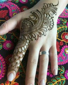 a woman's hand with henna on it