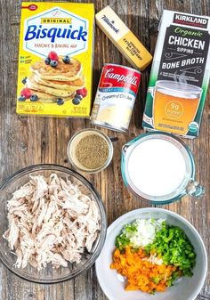 ingredients to make chicken and rice casserole laid out on a wooden table top