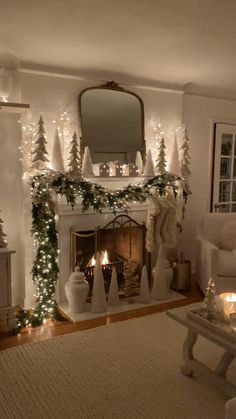 a living room decorated for christmas with lights on the fireplace and decorations around the fire place