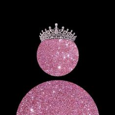 a pink glitter ball with a tiara on top