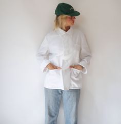 "Vintage white German chore work jacket dated from 1981. Three front pockets and one inner pocket. Roll up sleeves for casual look or wear buttoned up with a shirt. In excellent condition. Perfect for chilly summer days or transitional weather. Measurements are taken flat. Fits like M | Unisex* Shoulder to shoulder = 18 in / 46 cm Armpit to armpit = 22 in / 56  cm    Sleeve = 23.5 in / 60 cm Total length = 27.5 in / 70 cm Model is 5'6\", 26\" waist, 36\" hip and wears a modern 2-4 Fit guide: It' White Long Sleeve Utility Jacket With Patch Pockets, White Utility Jacket With Pockets, White Button-up Outerwear With Welt Pockets, White Outerwear With Patch Pockets For Work, White Button-up Utility Jacket With Pockets, Classic White Long Sleeve Utility Jacket, White Workwear Outerwear With Welt Pockets, White Utility Jacket With Patch Pockets, Classic White Utility Jacket For Work