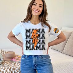 Cheer on your favorite player in style with this eye-catching Sports Mom T-shirt! Perfect for basketball events and showing mama pride, this shirt makes an excellent Mother's Day gift or a fun addition to any casual wardrobe. Customize it with a name to make it extra special. The vibrant design, comfortable fit, and durable fabric ensure you'll look great both on and off the court. Product Features: Fabrication: 100% Airlume combed and ring-spun cotton, 32 single 4.2 oz. (Ash - 99% Airlume combe Basketball Fan Apparel Tops With Short Sleeves, White Basketball Team Logo Tops, Cotton Basketball Top With Team Logo, White Basketball Team Logo Top, Cotton Top With Team Logo For Basketball, Graphic Tee With Team Logo For Basketball, Basketball Team Logo Short Sleeve Top, Basketball Team Logo Tops With Crew Neck, Basketball Tops With Team Logo And Crew Neck