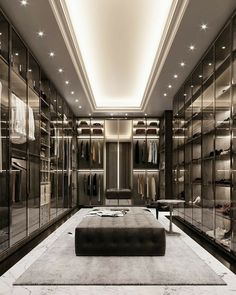 a large walk in closet filled with lots of clothes