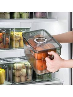 a person is opening the refrigerator door with food in it and holding an item inside