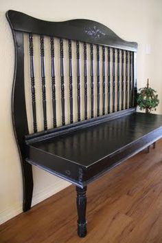 a black bench sitting on top of a hard wood floor