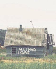 an old wooden building with the word allihad i gave written on it