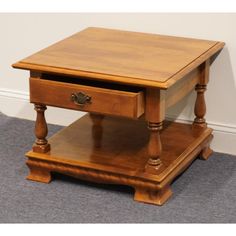 a small wooden table with two drawers