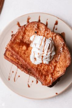 a piece of french toast topped with whipped cream