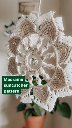 a close up of a flower on a plant with the words macrame suncather pattern