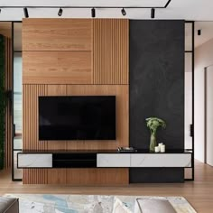 a modern living room with wood paneling and black walls