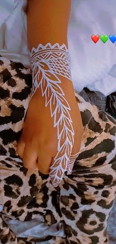 a woman's foot with white lace on it and hearts floating in the background