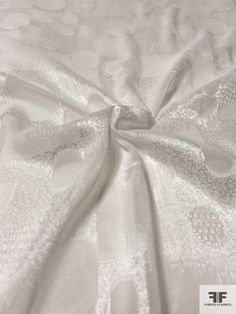 the white fabric is very soft and has an interesting pattern on it's surface