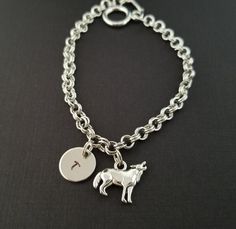 Personalized Antique Silver Wolf Bracelet!  A howling wolf charm on a lovely chain bracelet makes the perfect gift for you or your best friend.The wolf bangle charm is made from zinc alloy and measures 18 mm x 14 mm.  The bracelet is high quality zinc alloy and measures 8.5".  The wolf bracelet can be personalized with a .5" silver plated disc stamped with the initial of your choice.  The charm and initial disc are connected to the bracelet with sturdy split rings that will never fall off!  You Wolf Bracelet, Accessories Board, Ocean Bracelet, Best Friend Bracelets, Bracelet Initial, Wolf Jewelry, Memorial Bracelet, Silver Wolf, Howling Wolf