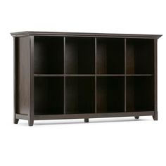 the bookcase is made from wood and has multiple compartments on each side, including one for