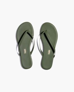 a pair of green sandals on a white background