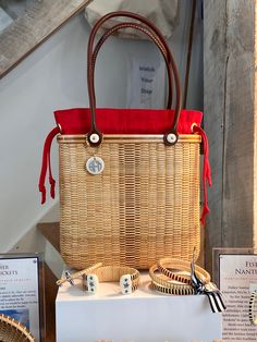 a wicker bag sitting on top of a table next to other items and signs