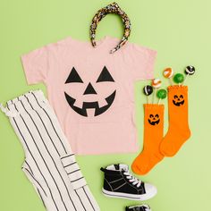 Jack O Lantern Face Features & Sizing*Crewneck, pullover styling*Short sleeves*Black or Orange PrintMaterials & Care*Soft Feel *100% Cotton *50% polyester, 25% combed & ringspun cotton, and 25% rayon *Machine wash cold, dry flat*Iron inside out Basic Pink T-shirt For Fall, Playful Crew Neck T-shirt For Fall, Playful Short Sleeve T-shirt For Fall, Playful Short Sleeve Fall T-shirt, Jack O Lantern Faces, Face Features, Halloween Adventure, Daisy Girl, Summer Graphic Tee