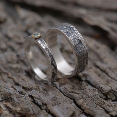 Unique set of two matching wedding rings inspired by the tree bark of an old olive family tree. Mixed precious metal rings made from sterling silver (men's band) and sterling silver and gold 14KT (women's band). On the top of womens band a natural gemstome of your choice is nested in 14KT gold. Custom made to your finger sizes. The price is for the set (two rings, one for the bride and one for the groom). The width of the men's band is 6mm and 2.5mm for the women's.Extremely strong and durable. Nature-inspired Anniversary Rings With Polished Finish, Anniversary Nature-inspired Rings With Polished Finish, Nature-inspired Polished Jewelry For Anniversary, Nature-inspired Silver Rings For Anniversary, Nature-inspired Silver Anniversary Rings, Nature-inspired Hammered Jewelry For Anniversary, Matching Wedding Rings, Wedding Band Sets, Sterling Silver Mens