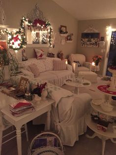 a living room filled with furniture and christmas decorations