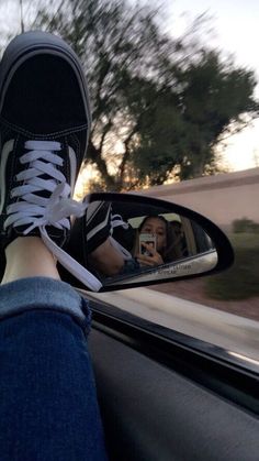 the person is taking a selfie in their car mirror