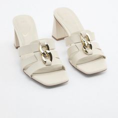 Sandals With Mid-Height Block Heels. Front Straps With Chain Detail. Squared Toe. Heel Height: 2.8 Inches (7 Cm) Airfit. Flexible Technical Sole Made Of Latex Foam Designed To Offer Increased Comfort. Size Eu39/Us8 Off White Color 3304/010 Upper 100% Polyurethane Lining 100% Polyurethane Sole 100% Polyurethane Thermoplastic Insole 100% Polvurethane S43 Summer Open Toe Heels With Chain Strap, Summer Formal Sandals With Chain Strap, Formal Summer Sandals With Chain Strap, Chic Synthetic Sandals With Chain Strap, Elegant Summer Sandals With Chain Strap, Summer Heels With Chain Strap And Open Heel, Summer Open Heel Heels With Chain Strap, Summer White Heels With Chain Strap, White Summer Heels With Chain Strap