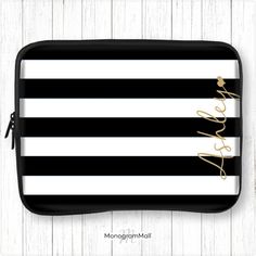 a black and white striped lunch box with gold lettering