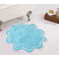 a bathroom rug that is on the floor in front of a bathtub and sink