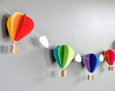 colorful hot air balloons are hanging on the wall