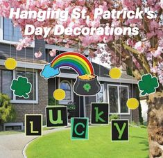 a lawn decorated with st patrick's day decorations in front of a house and tree