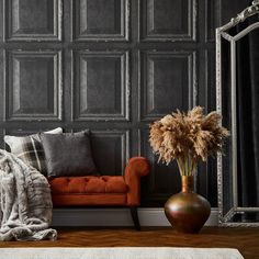 a living room with a couch, mirror and vase on the floor that says i love wallpaper