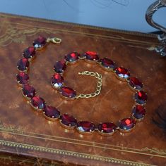 "This beautiful necklace is made with rich, sparkly Aurora Crystals in a dark Ruby red.  Absolutely Luscious! 18x13mm Stones (about 1\" long each) This style is slightly longer than my usual necklaces, measure 17\" with a 3\" extension chain.  Gold-plated brass settings.  Nickel Free! Can be ordered with matching earrings- you may select that option at checkout!" Red Polished Gem Necklace, Red Spinel Necklace, Red Crystal Jewelry, Riviere Necklace, Crystal Jewelry Necklaces, Garnet Red, Anna Wintour, Necklace Red, Pretty Clothes